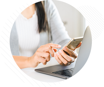 Person using a smartphone and a laptop